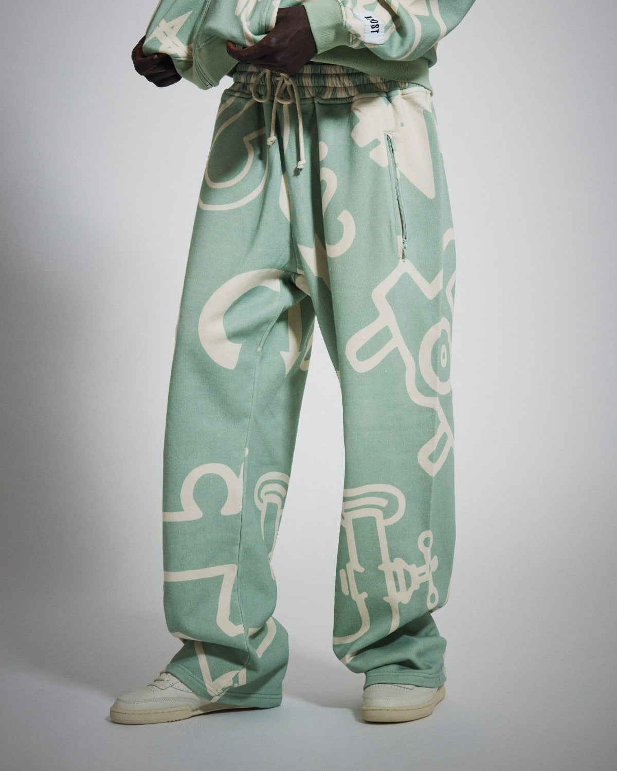 KROST x Monopoly | Free Parking large all-over graphic cream printed straight leg light green sweat pant